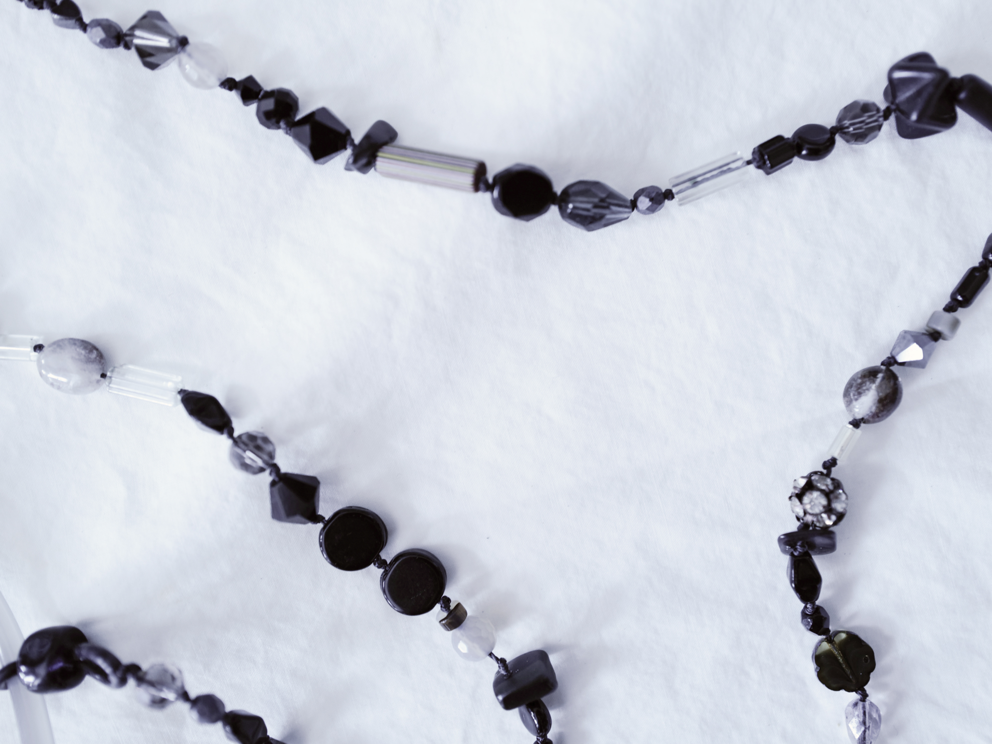Smoky gray glasses chain on white linen