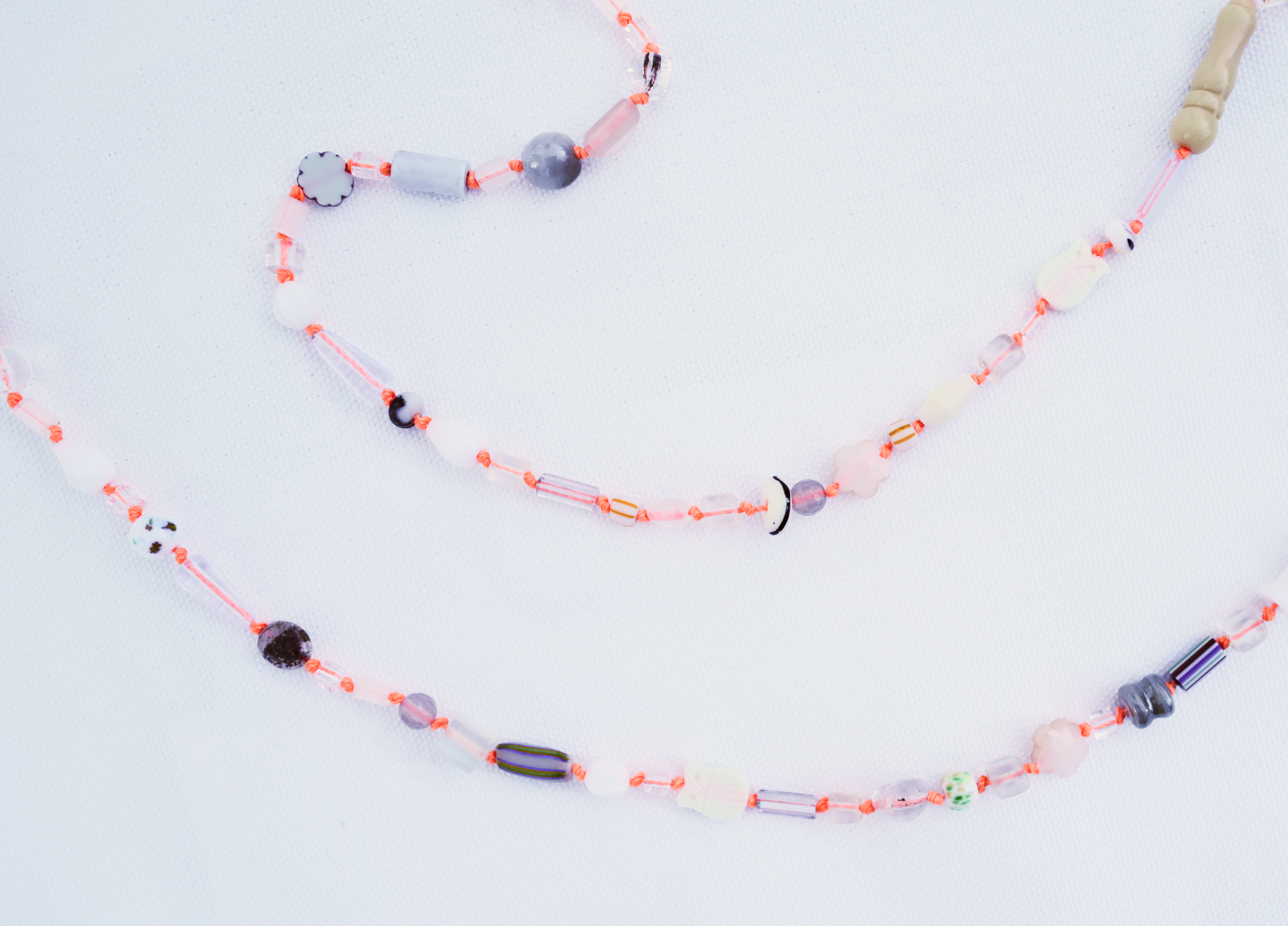 Orange cord glasses chain on white linen